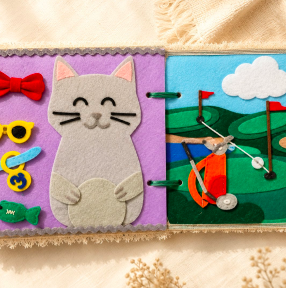 Open felt quiet book with cat and golf activity pages